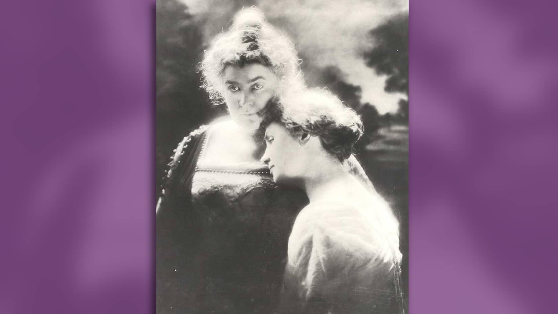 Helen Keller lays her head on Anne Sullivan's shoulder