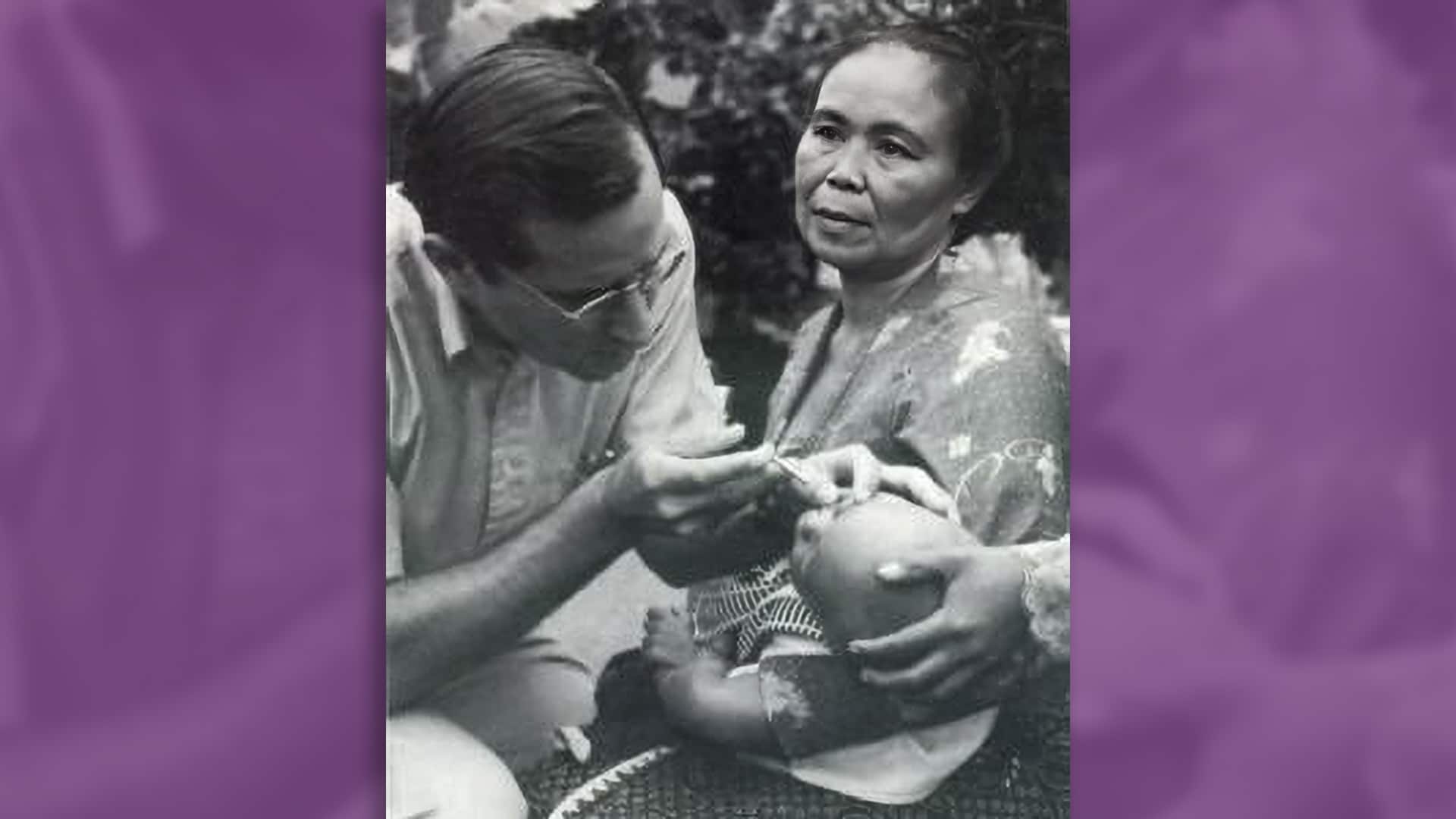 Doctor administering vitamin A to young child