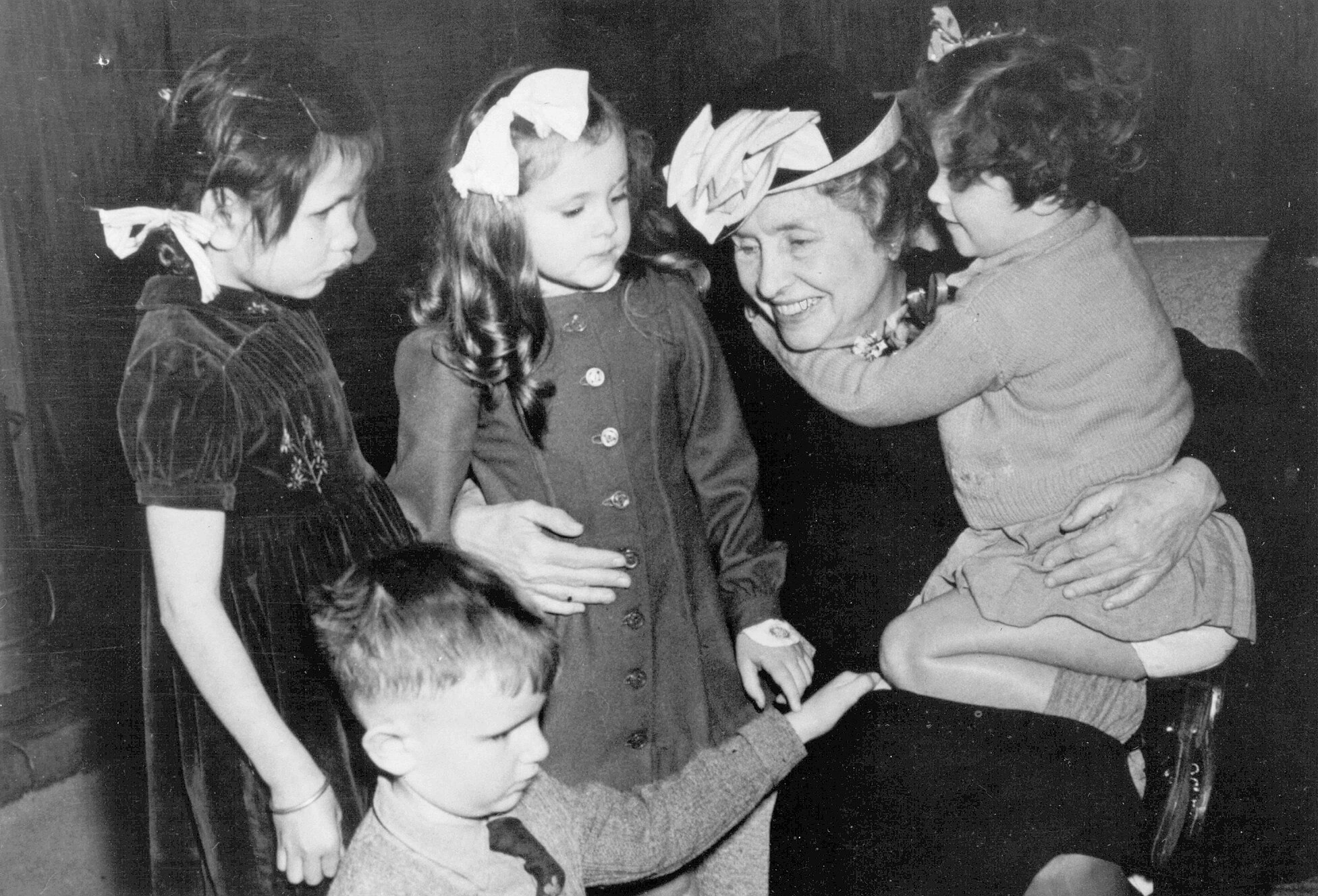 Accomplishing Small Tasks Helen Keller seated with four children