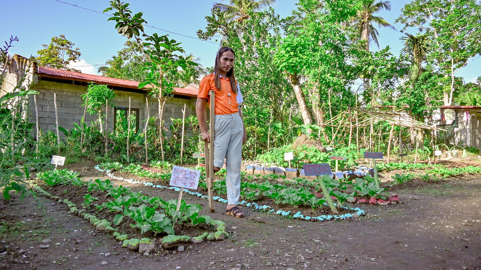 Woman walks among a small community garden