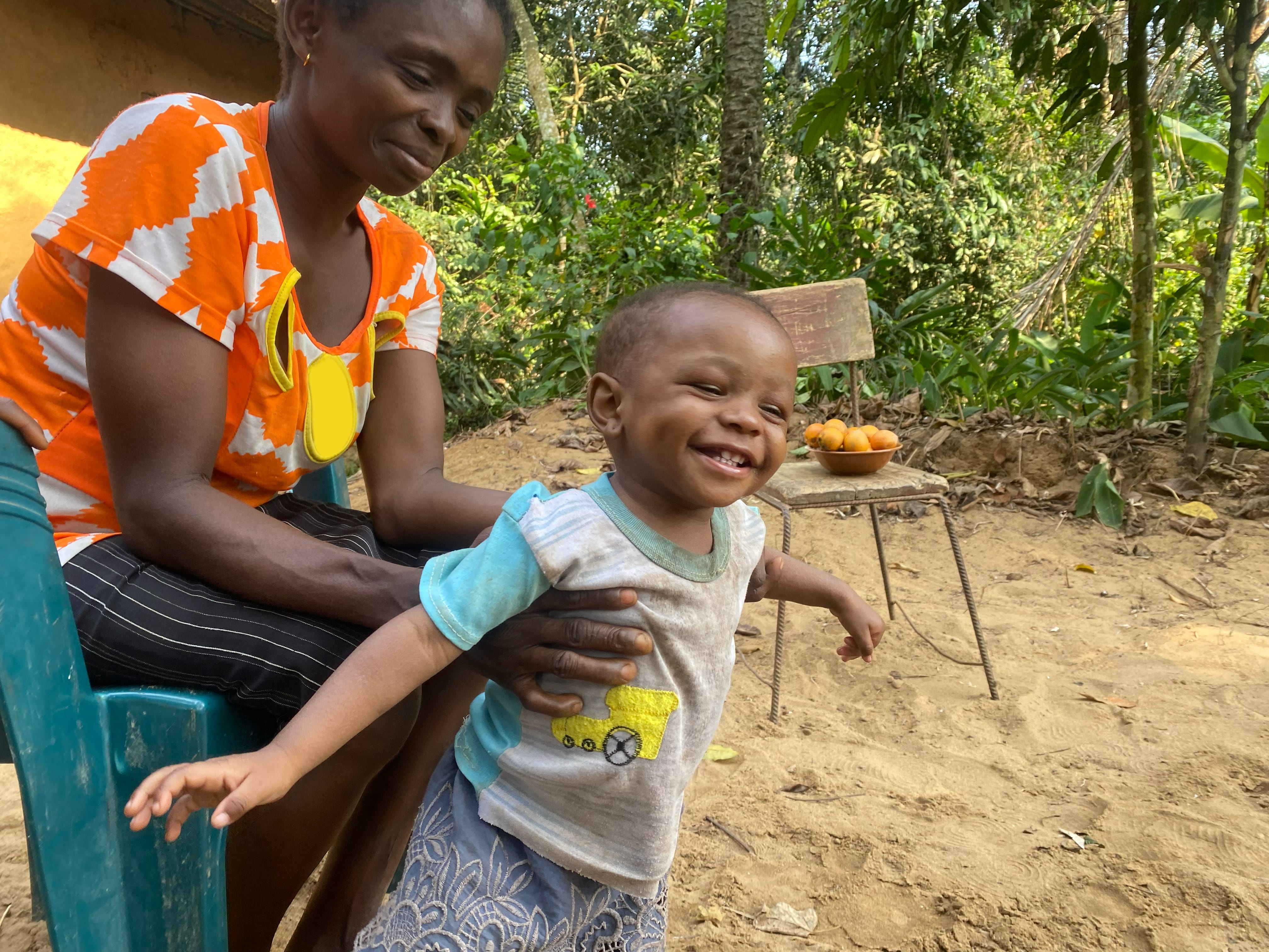 Mother holds her young, smiling child