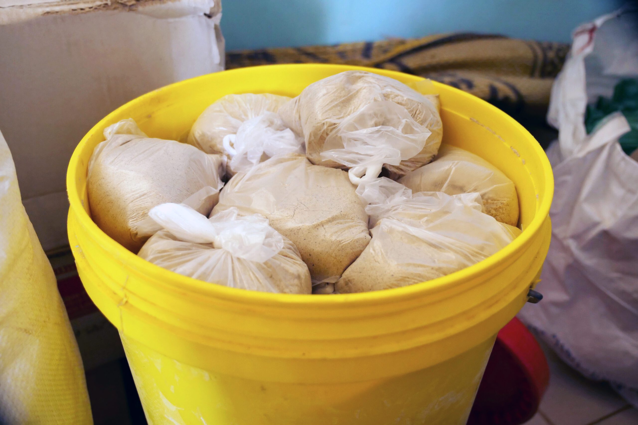 A bucket full of special porridge mixes containing millet, corn, and rice flours combined with pulverized peanuts and black-eyed peas. 