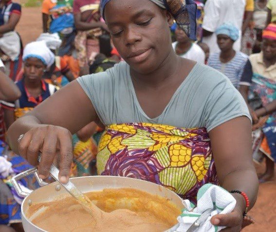 A woman preparing porridge using locally grown ingredients
