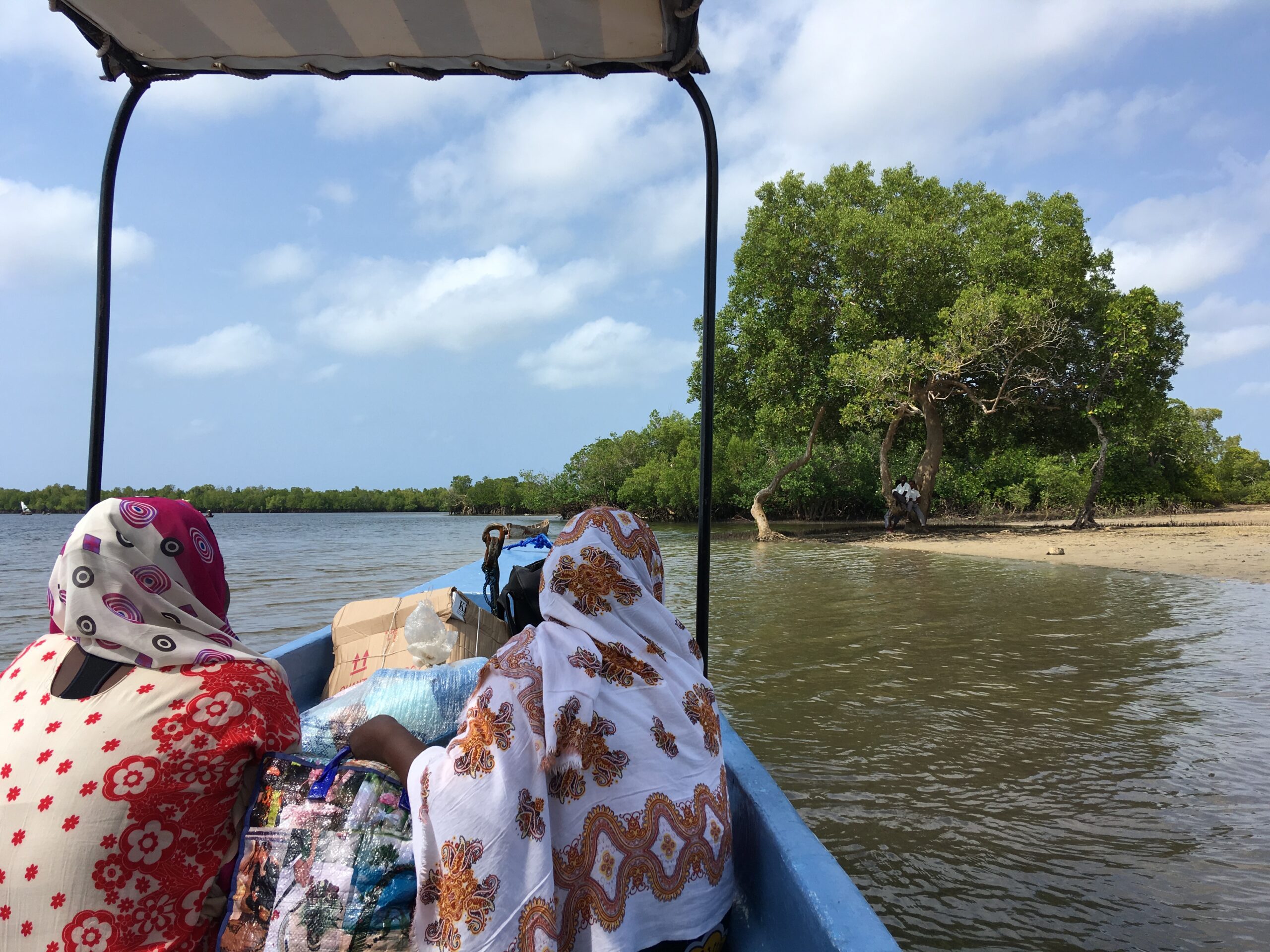 Passengers riding in a speedboat toward Funzi island