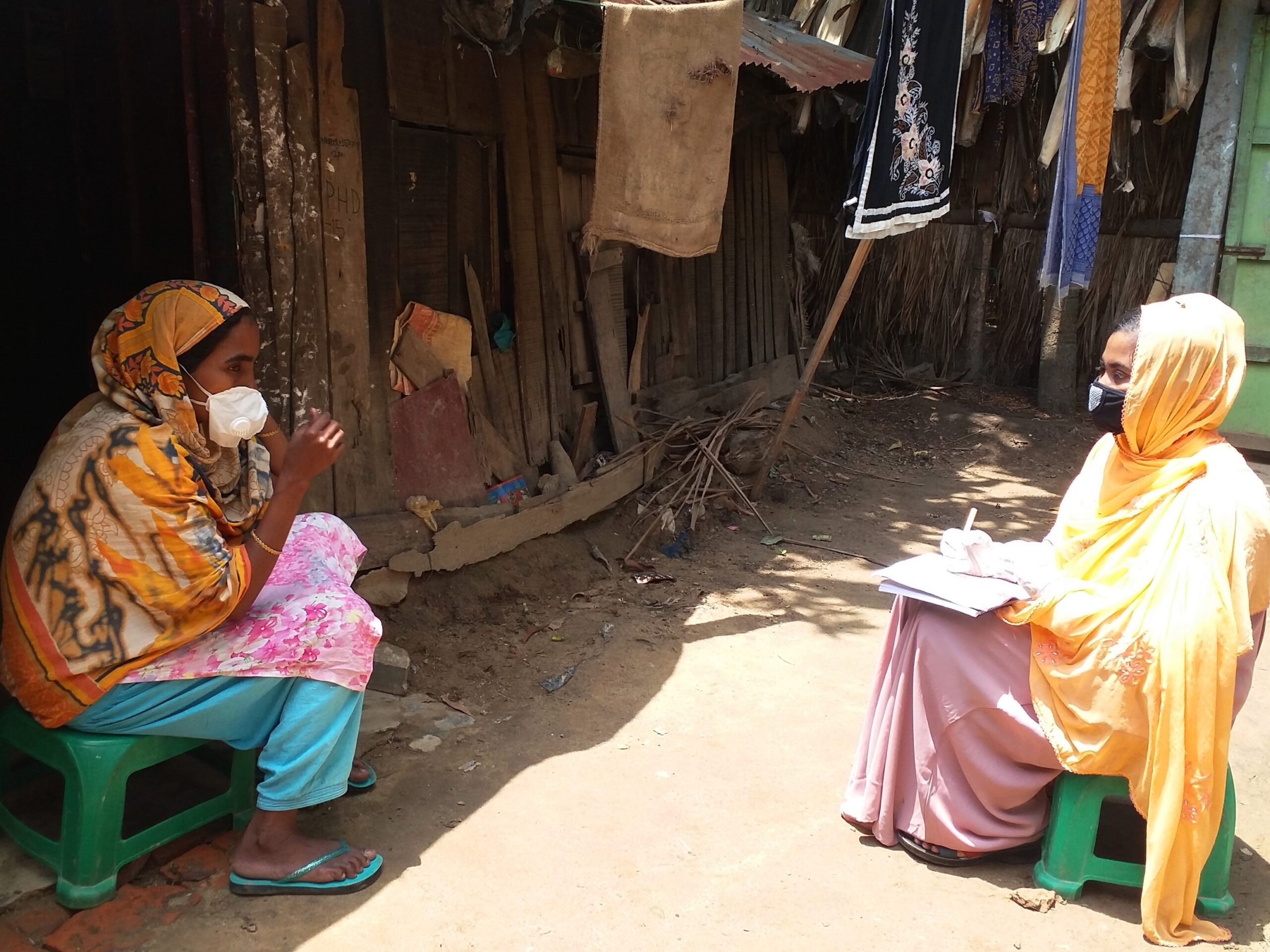 A community facilitator visits a household to share hygiene and sanitation information 
