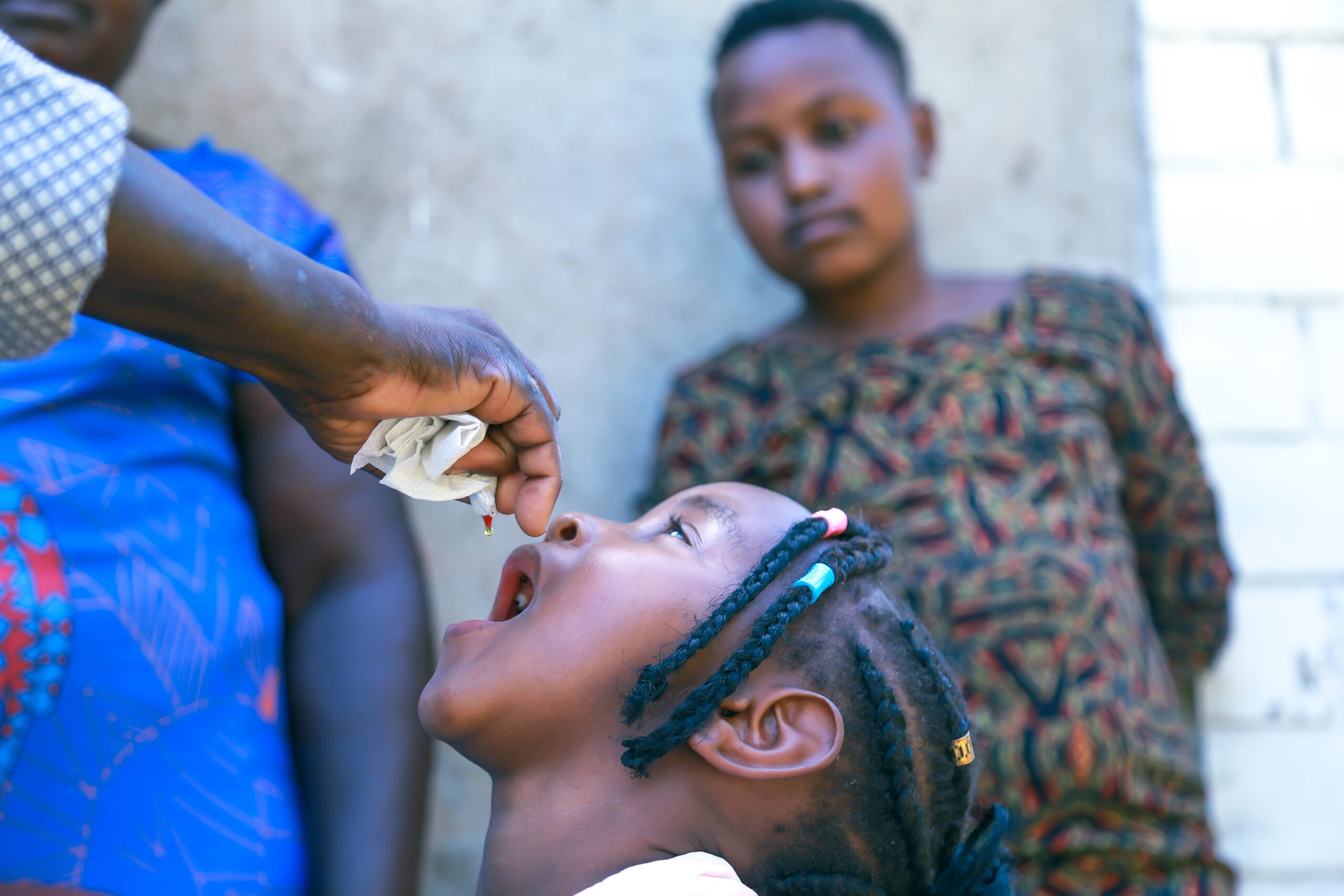 A young girl receiving a dose of Vitamin A.
