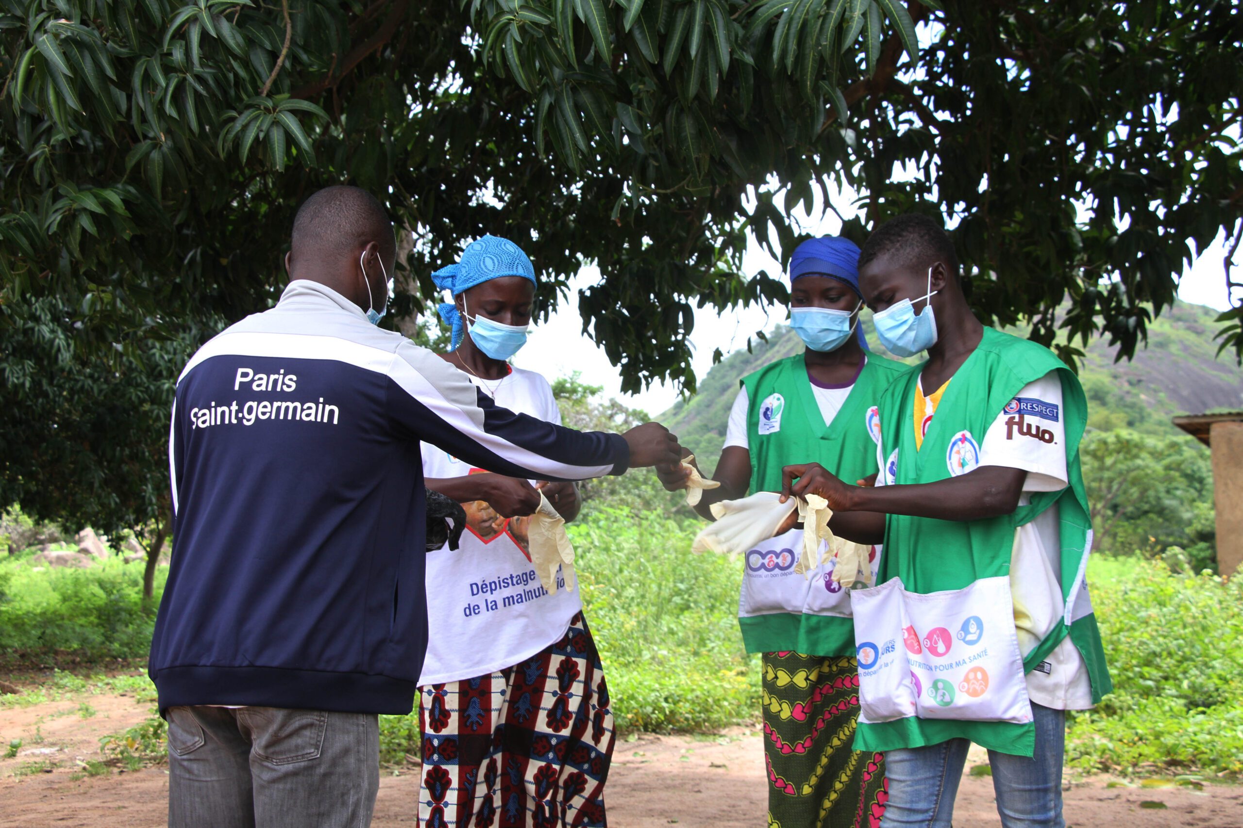 A team of vitamin A distributors dons masks and puts on gloves to prevent the spread of COVID.