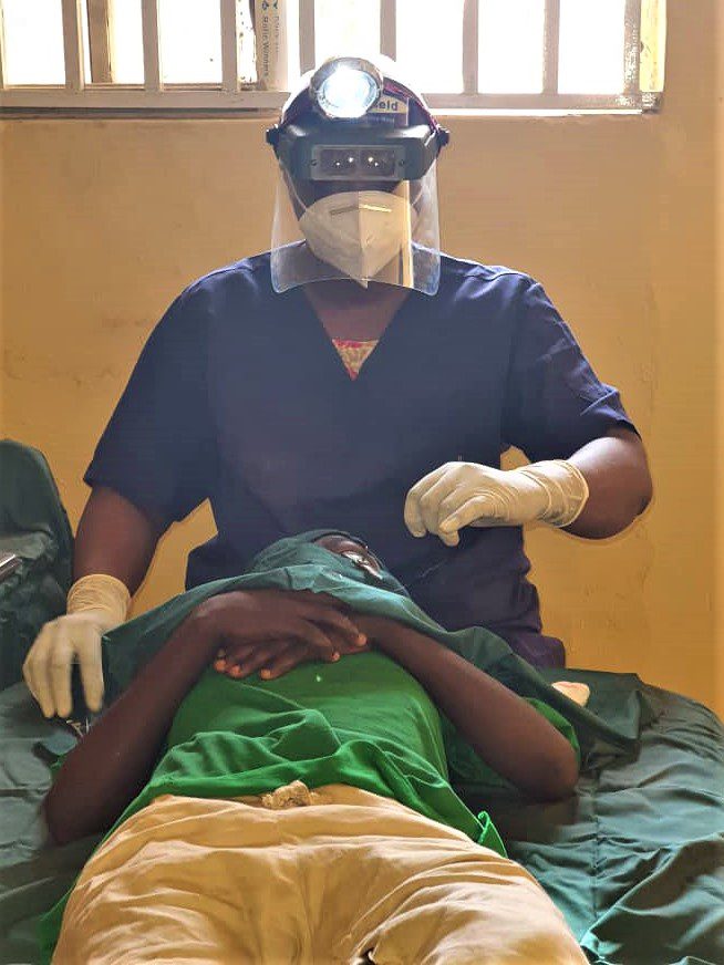 A health worker screening a patient for trachoma