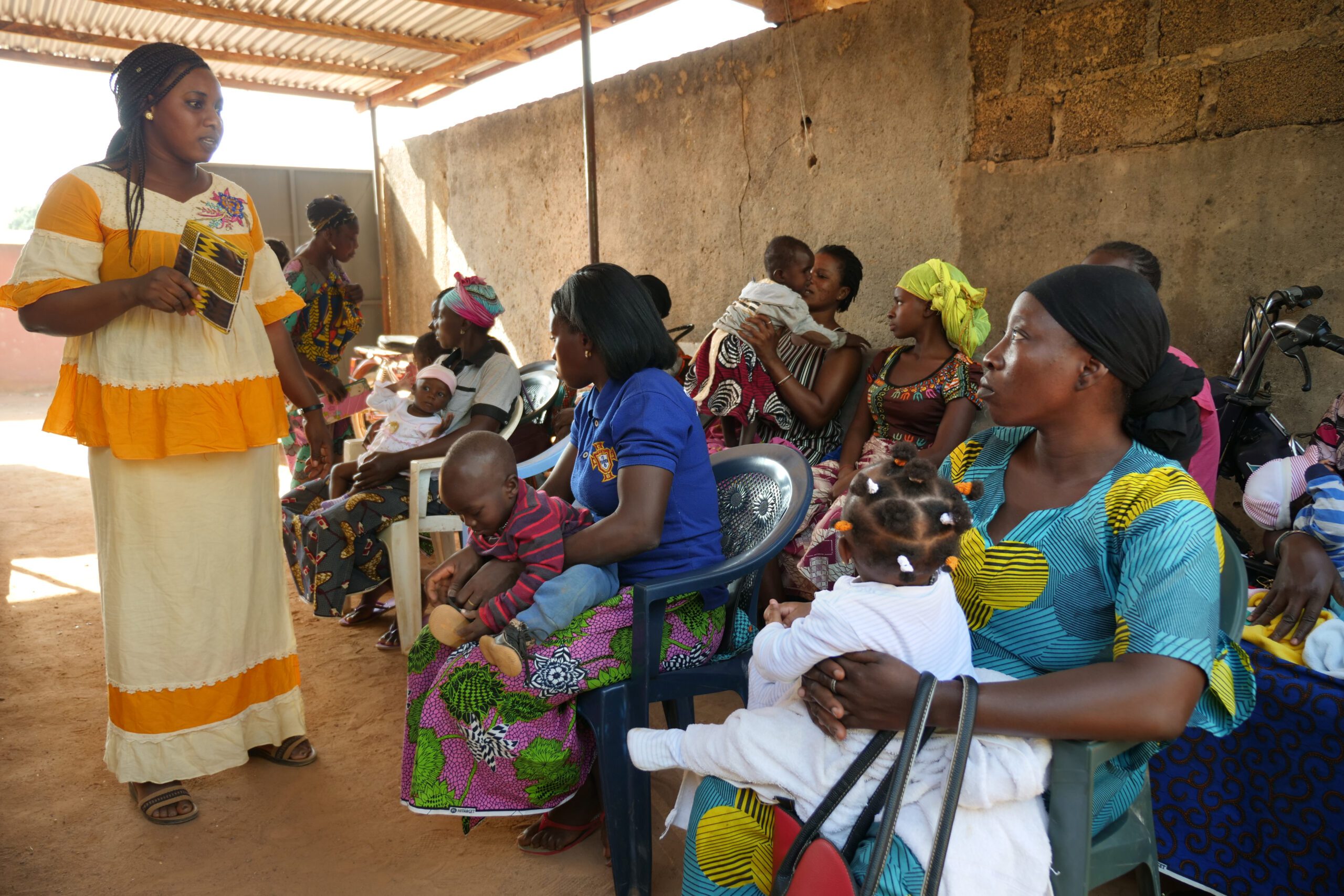A Wo Pile Sanga employee talks to mothers from the community during an education session