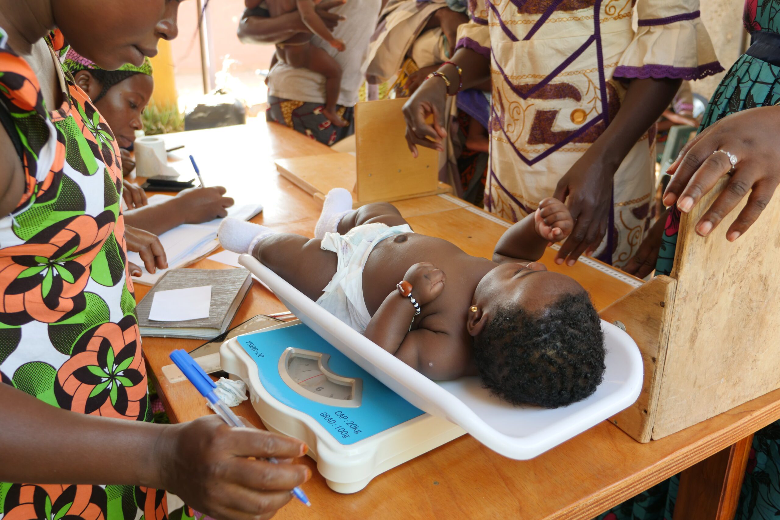 A small baby on a scale during a nutrition screening