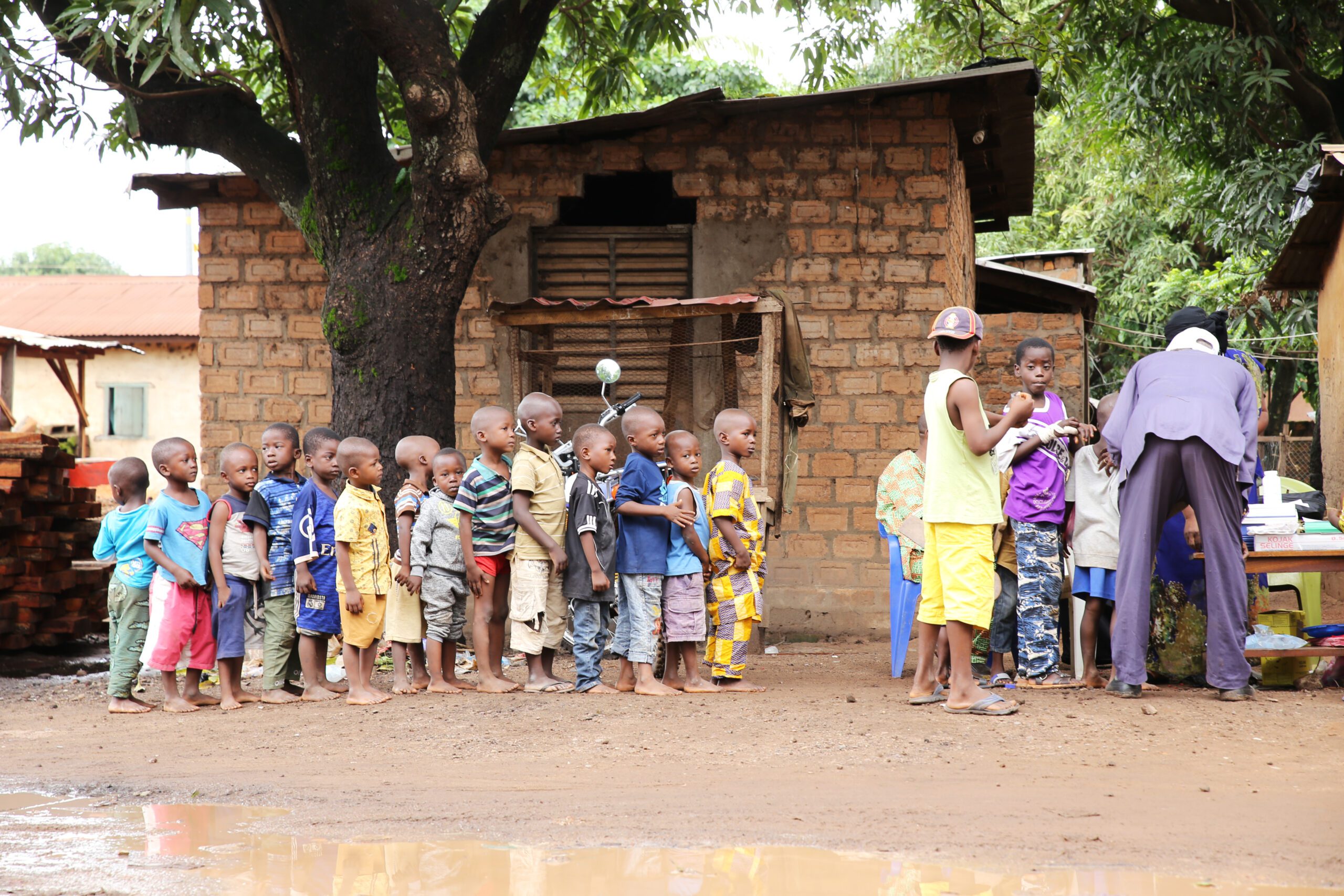 Children line up to receive vitamin A supplementation in Guinea
