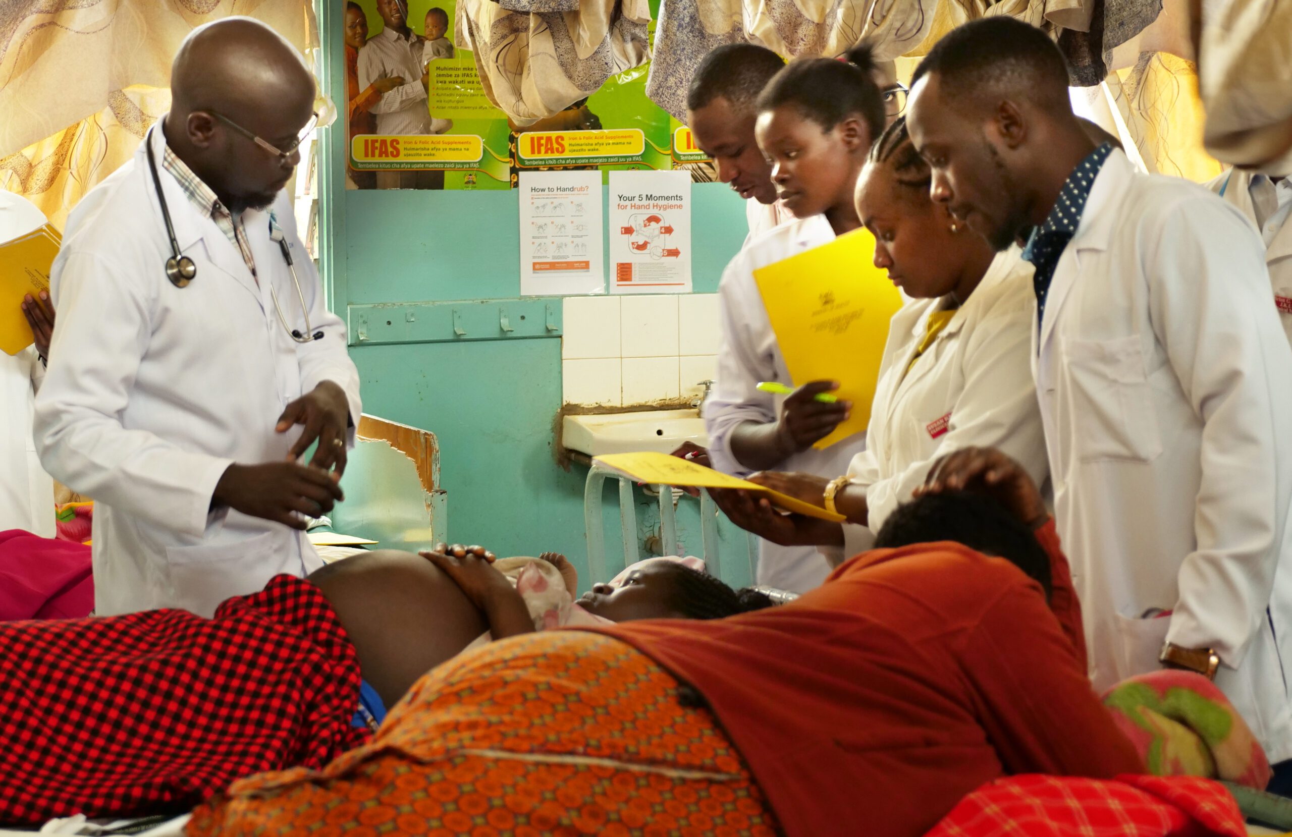 Medical staff in the maternity care ward at Kitale County Referral Hospital attend to patients. 