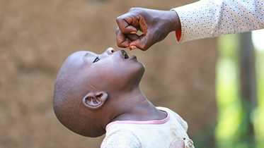 A young child receives a dose of medicine