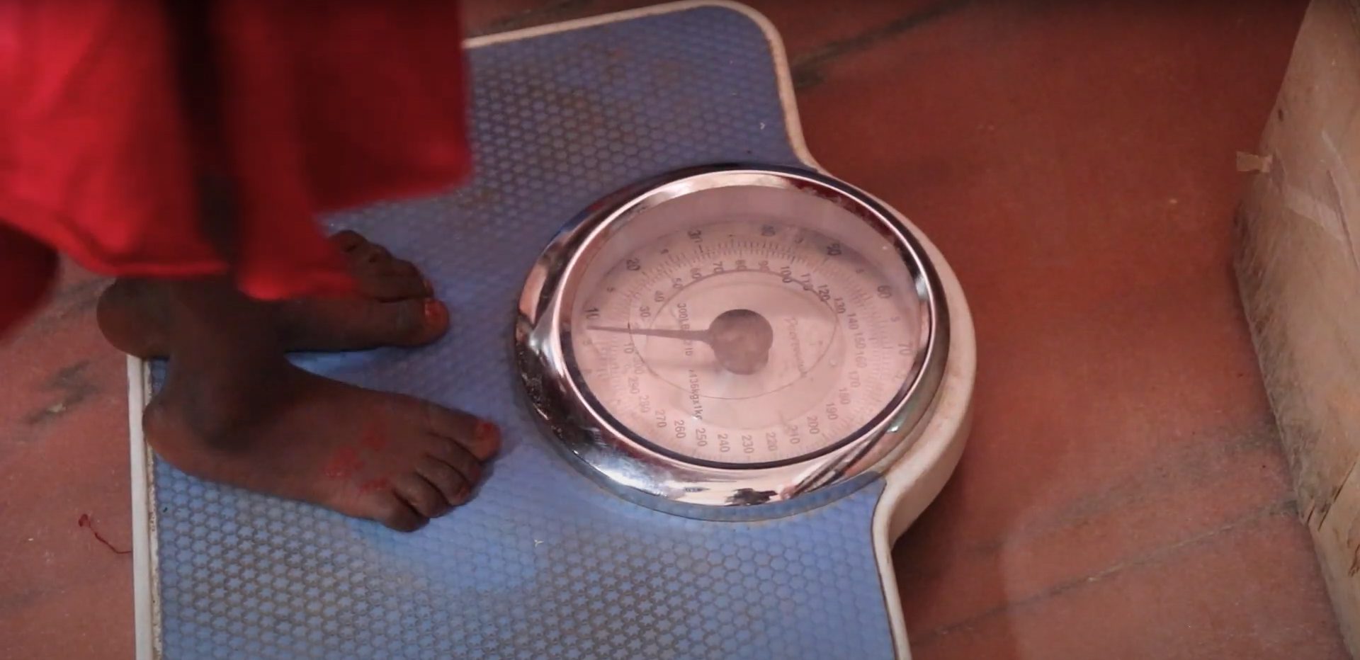 A child's feet standing on top of a scale