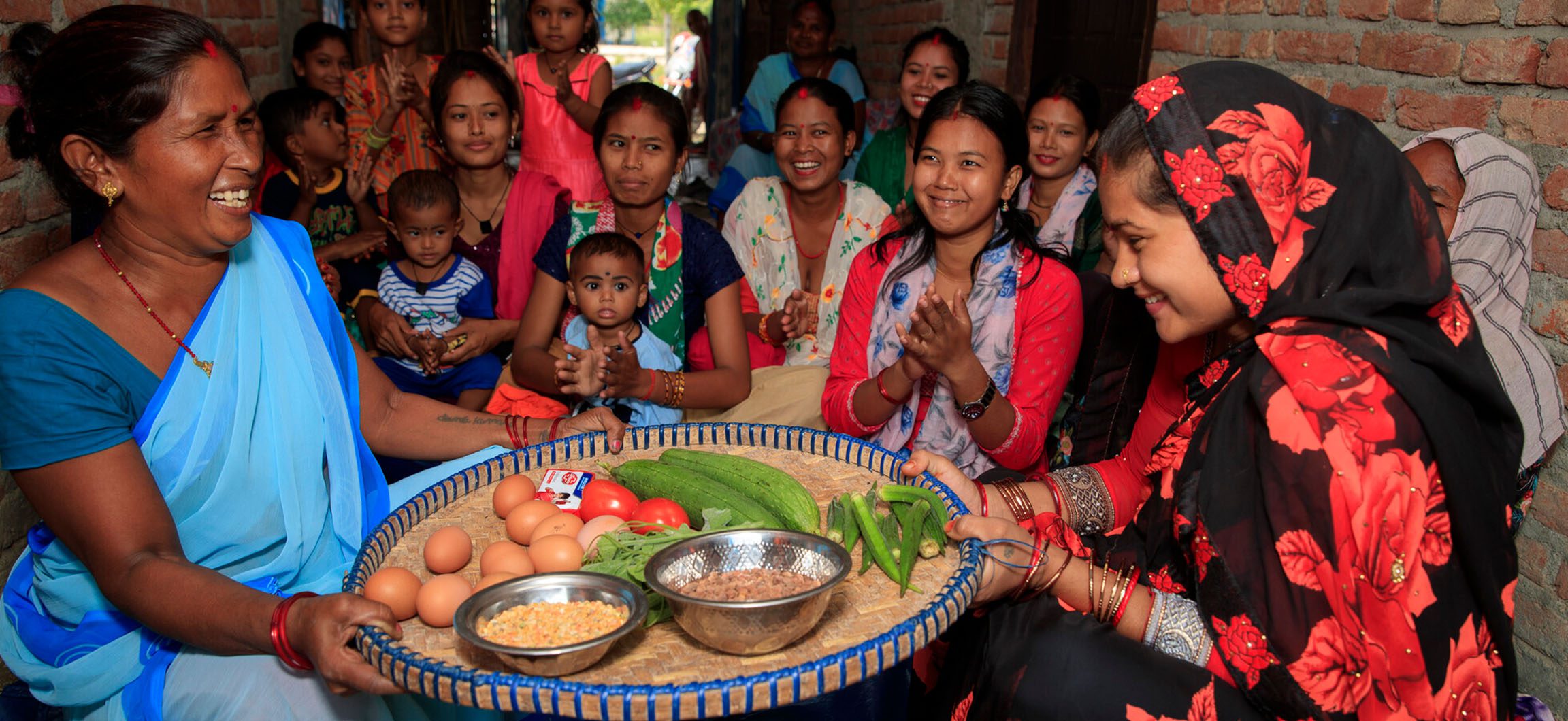 Nepalese mothers celebrating with food.