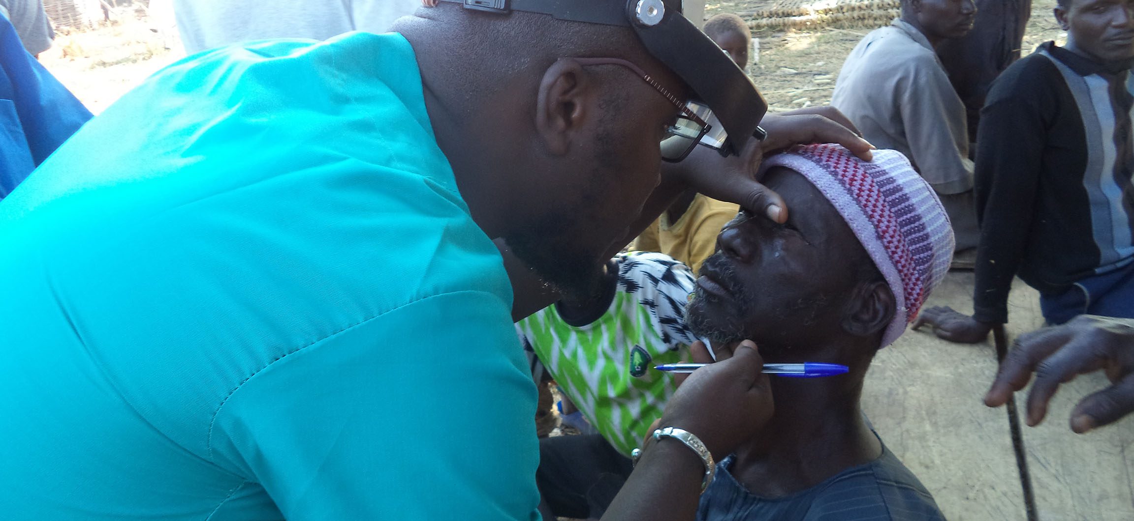 Health worker examines person for Trachoma.