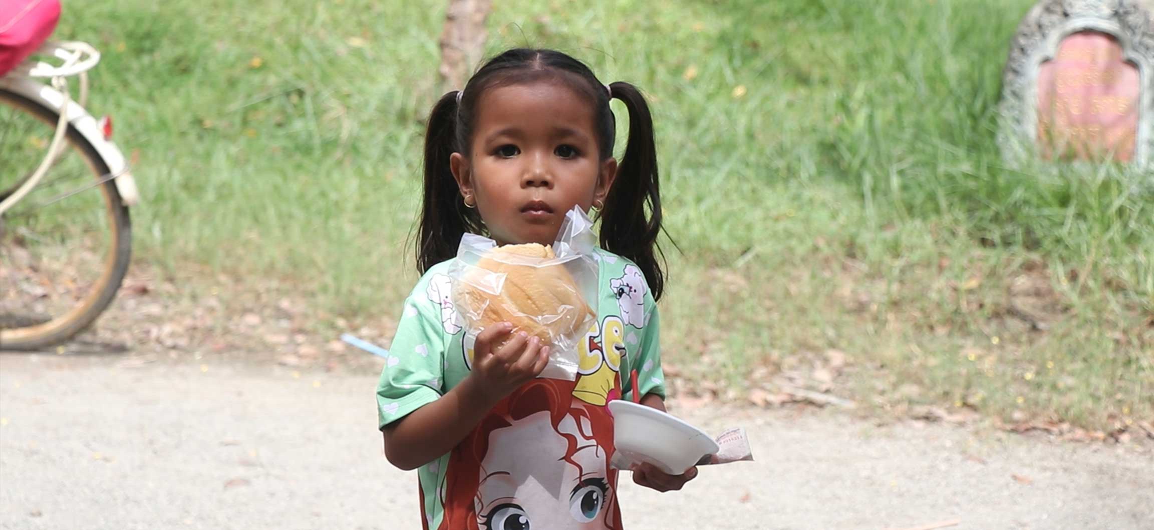 Child holding food.