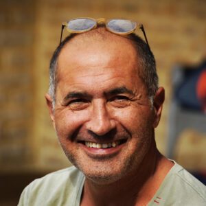 Headshot of smiling man with glasses