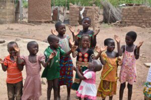 Group of young children smiling and clapping in Senegal.