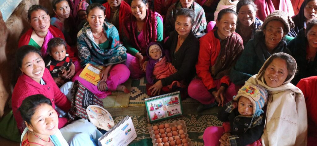 Group of women and infants sitting in a semi circle