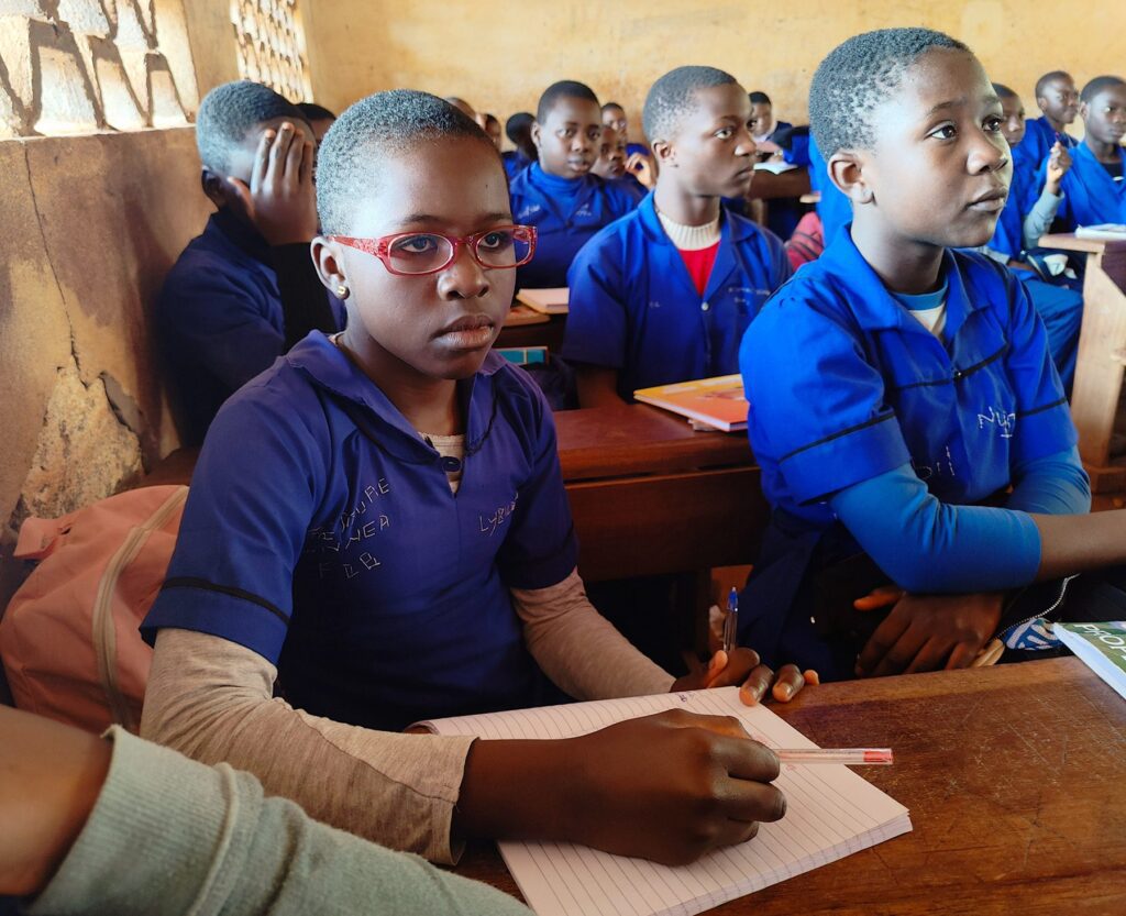 Student writing notes in classroom setting