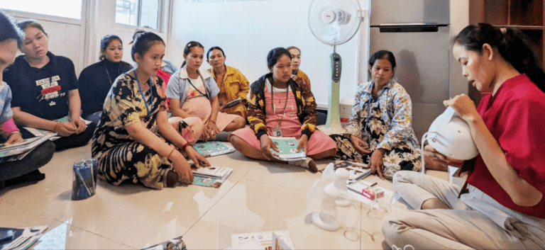 Women learning breastfeeding techniques in workshop