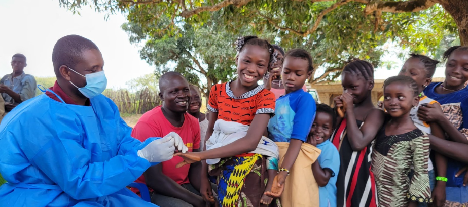 A healthcare worker with a group of children