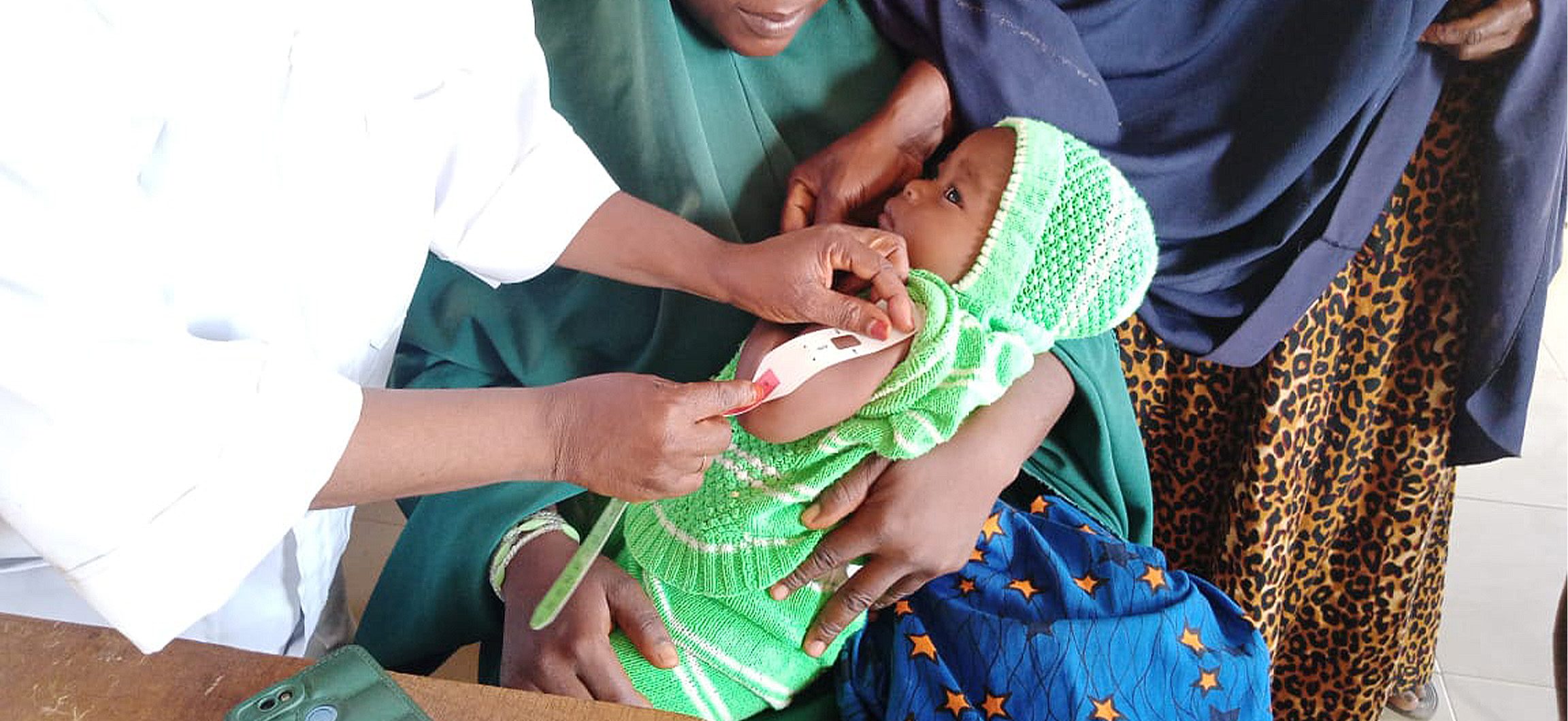 Young baby measured for malnutrition.