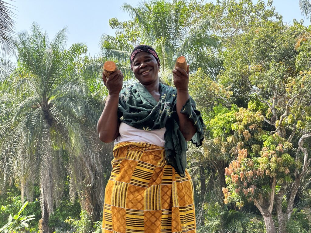 Woman holding freshly harvested sweet potatoes outdoors