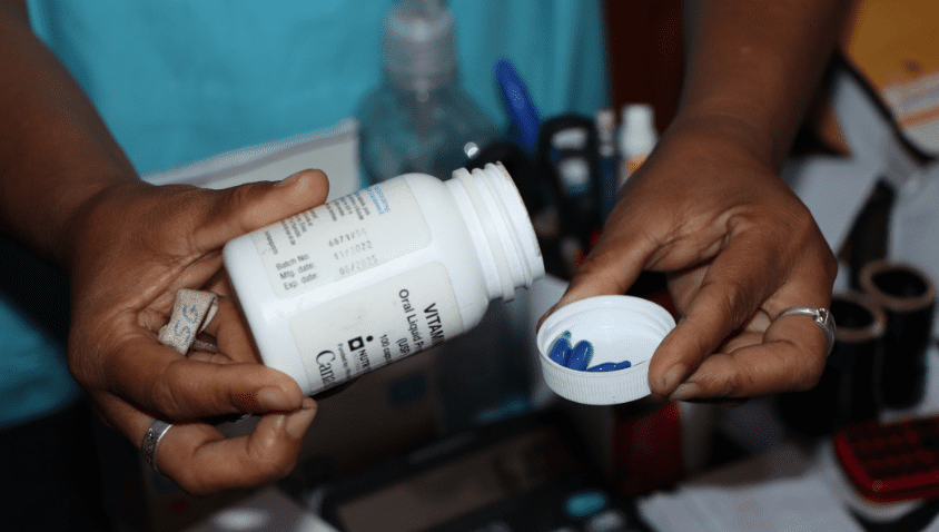 Measuring liquid medication into a plastic cup