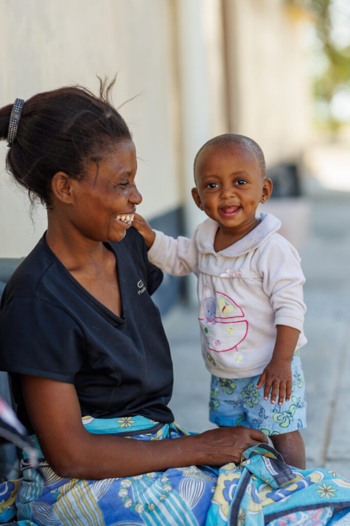 A Kenyan mother smiles at her baby.