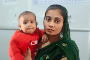 Baby Naina being held by her mother.