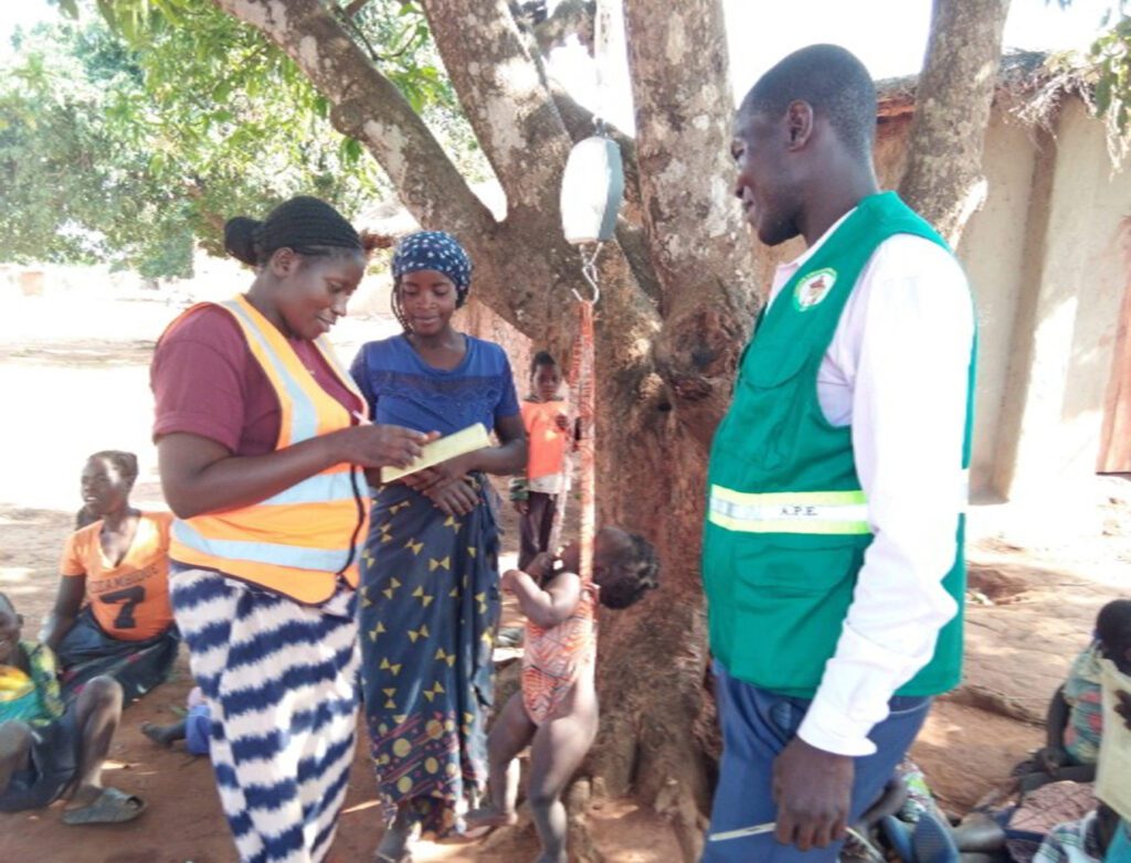 A baby is weighed during a malnutrition screening.