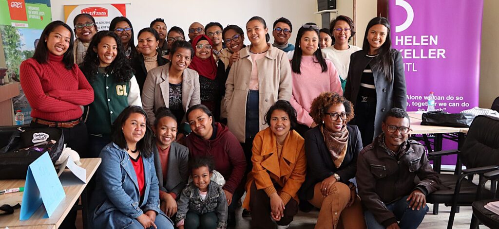 Diverse group smiling at Helen Keller event