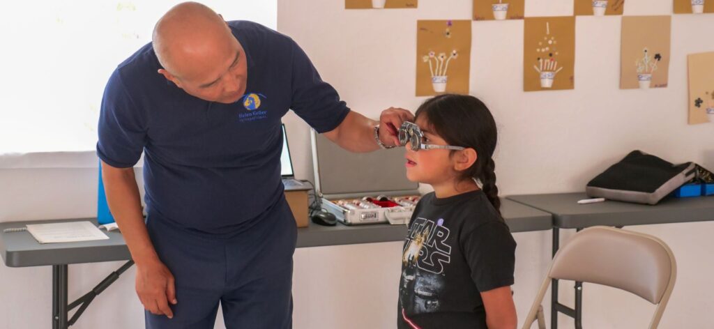 Optometrist testing vision of young girl