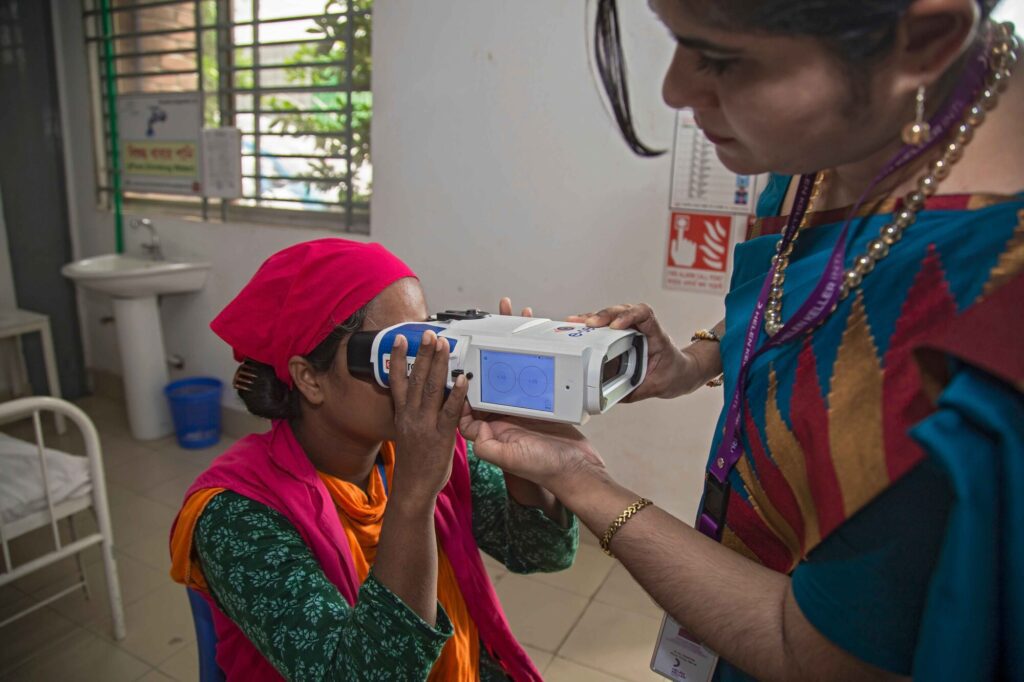 Woman receiving handheld eye vision test