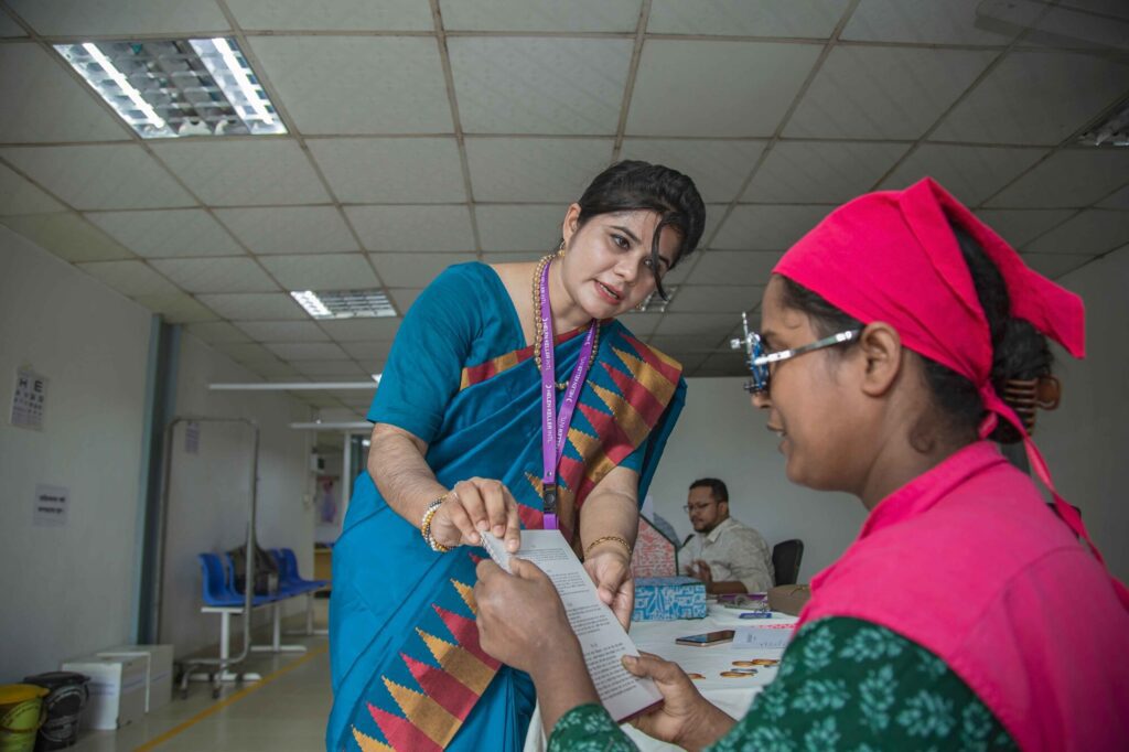 Woman assisting patient with eye test booklet