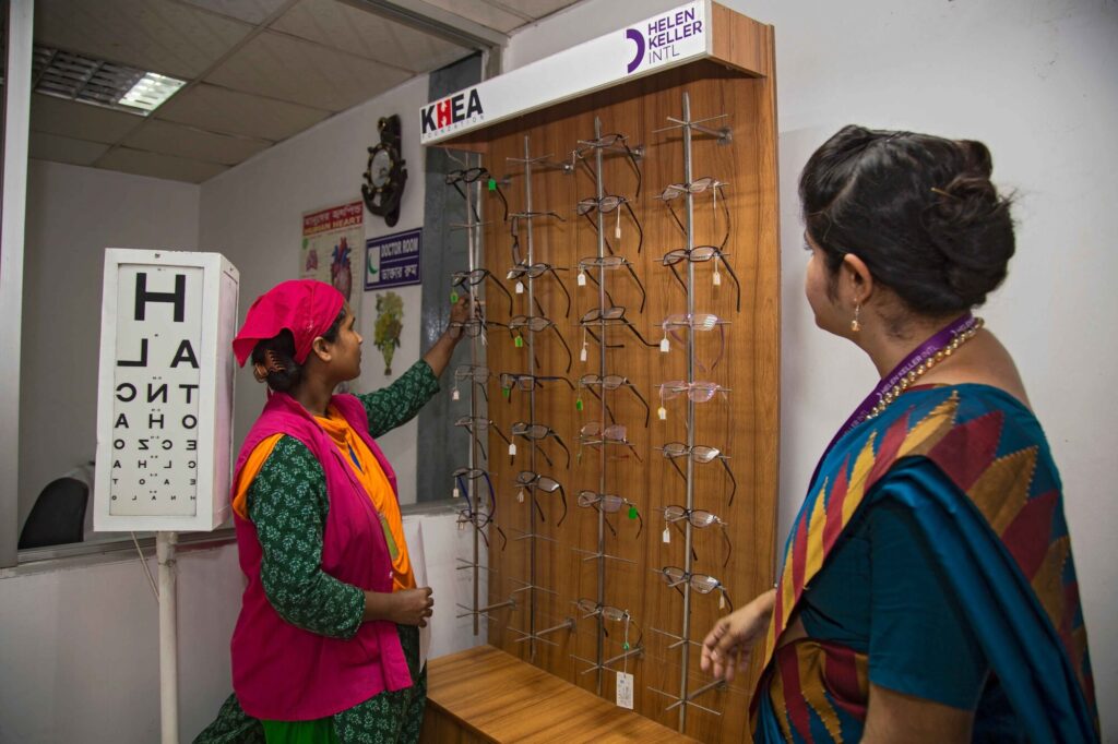Woman choosing eyeglasses at optical clinic