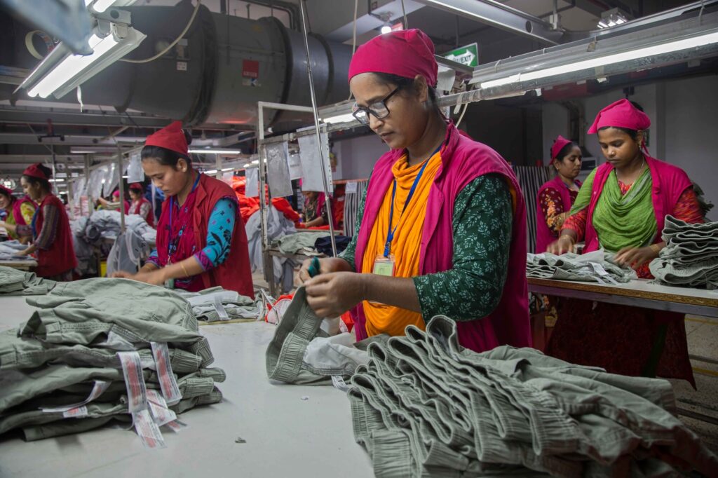 Women folding pants in garment factory