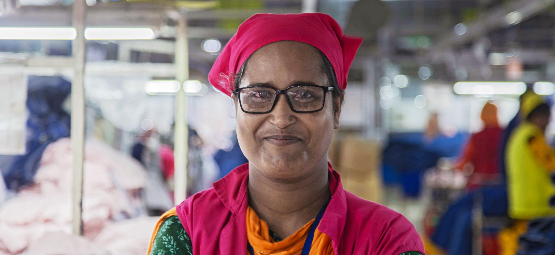 Smiling woman factory worker with red headscarf