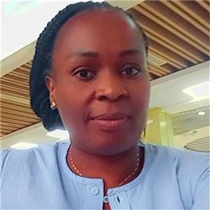 Woman in blue blouse sitting indoors