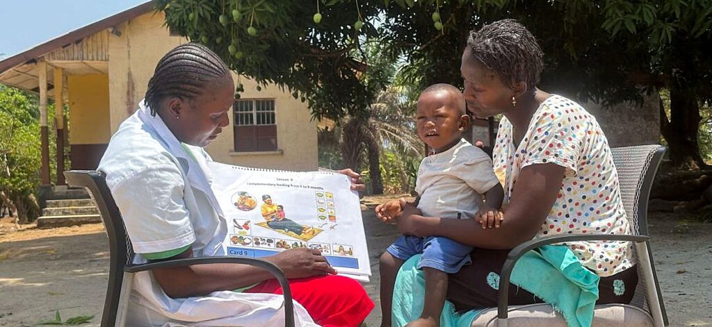 Health worker teaching mother and child nutrition