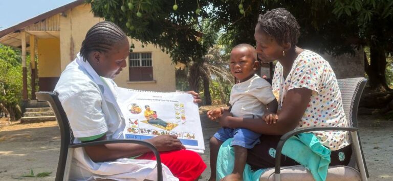 Healthcare worker teaching mother child nutrition