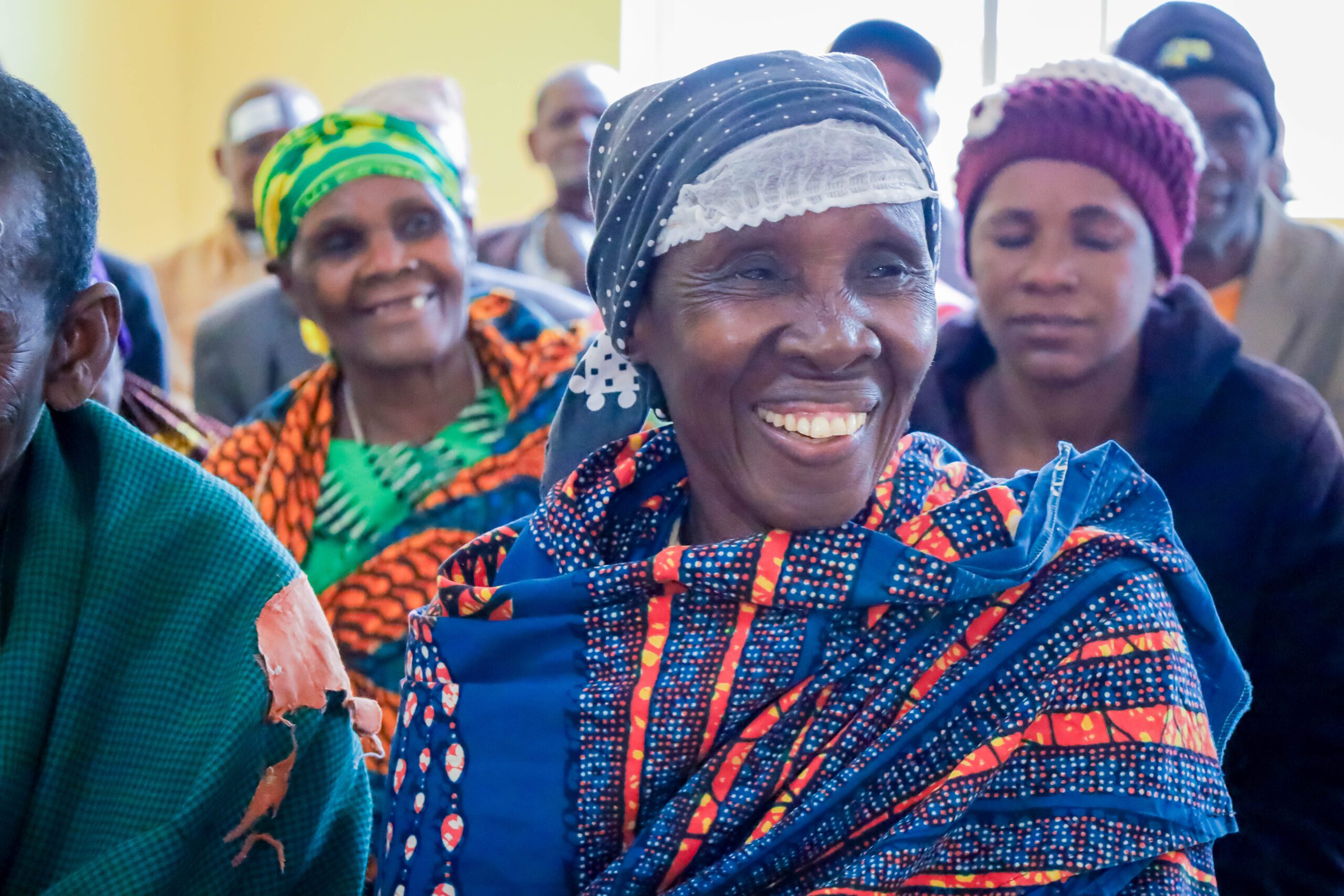 Elderly African woman smiling in traditional clothing
