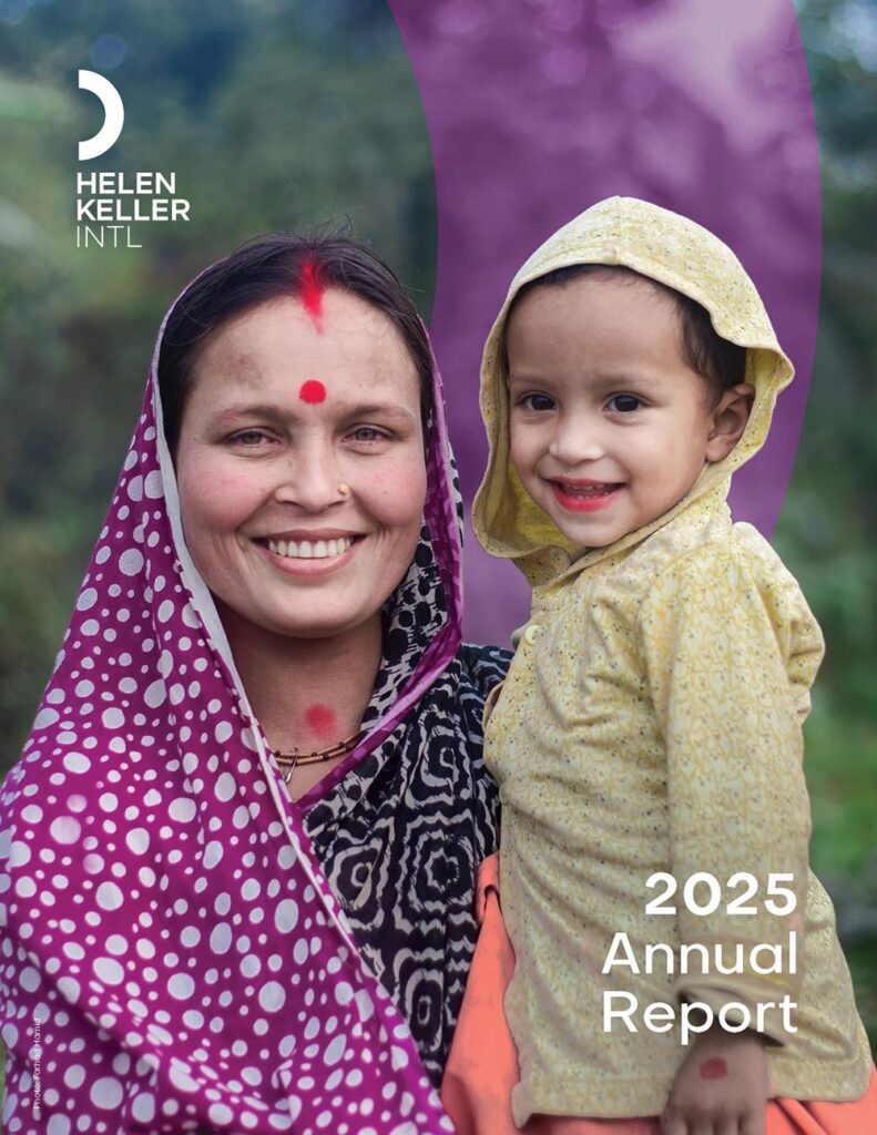 Woman in purple scarf holding smiling child