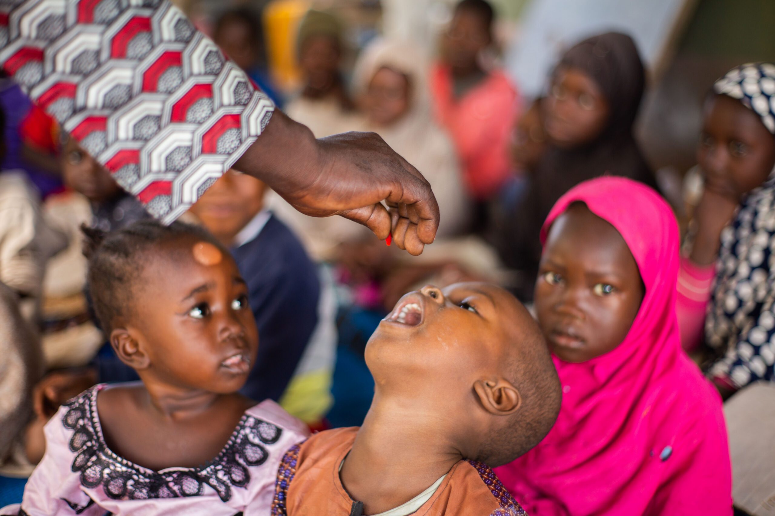 Child receiving oral drop