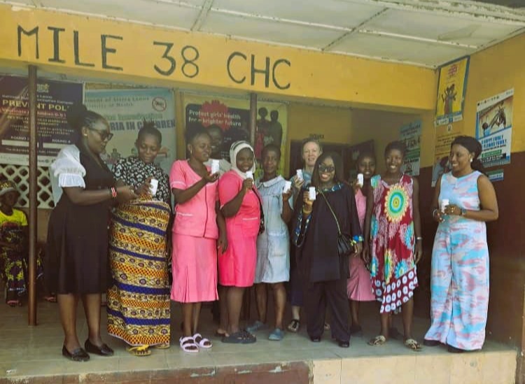 Women holding medication bottles at health center