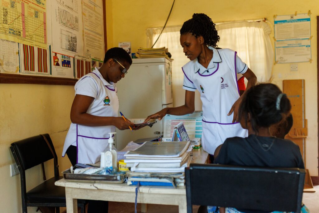 Healthcare workers reviewing patient records in clinic