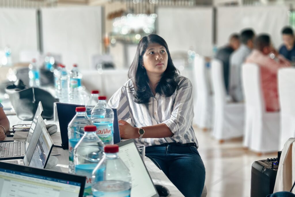 woman in meeting with laptops and water bottles