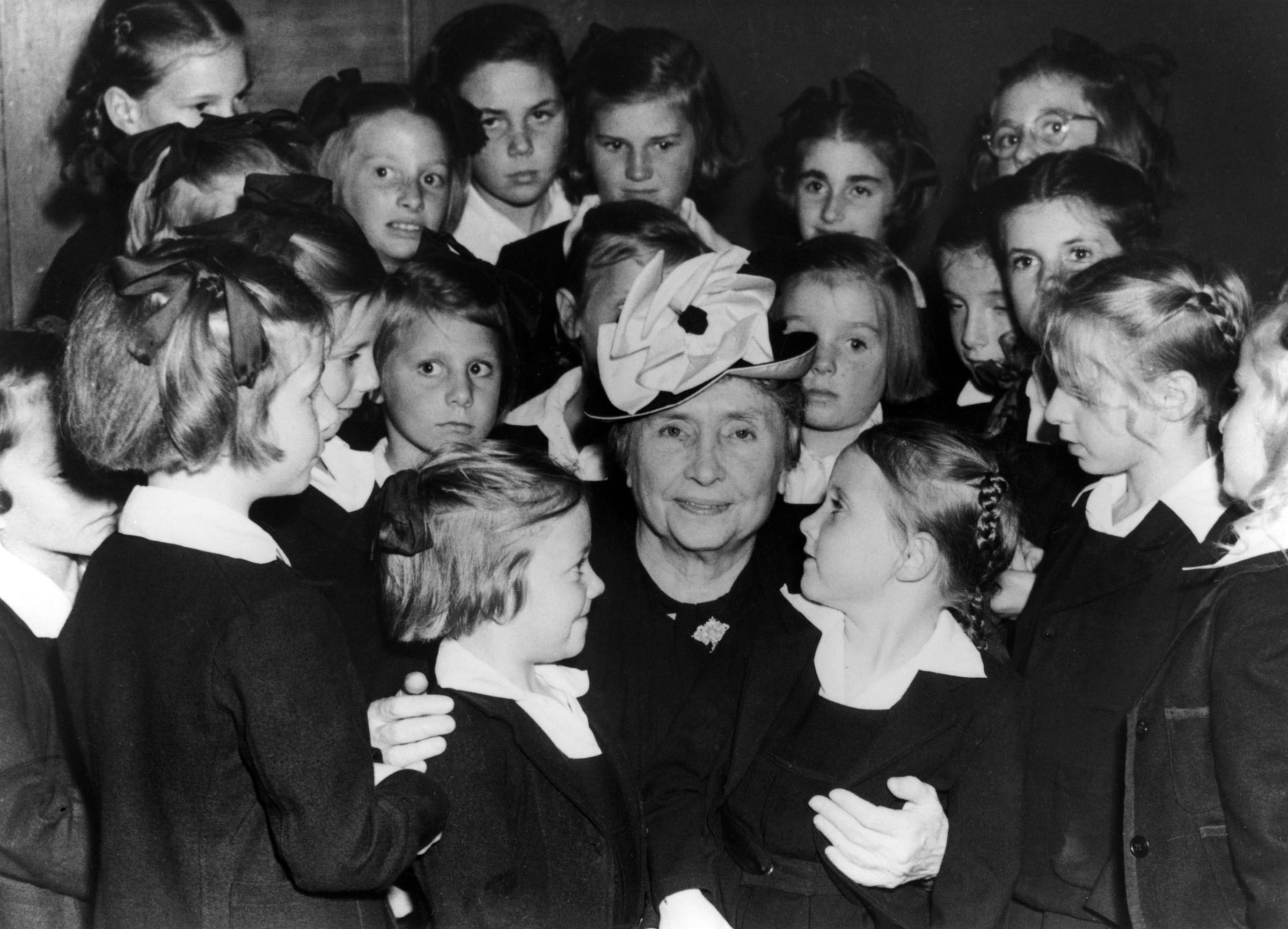 Helen Keller posing with a group of children